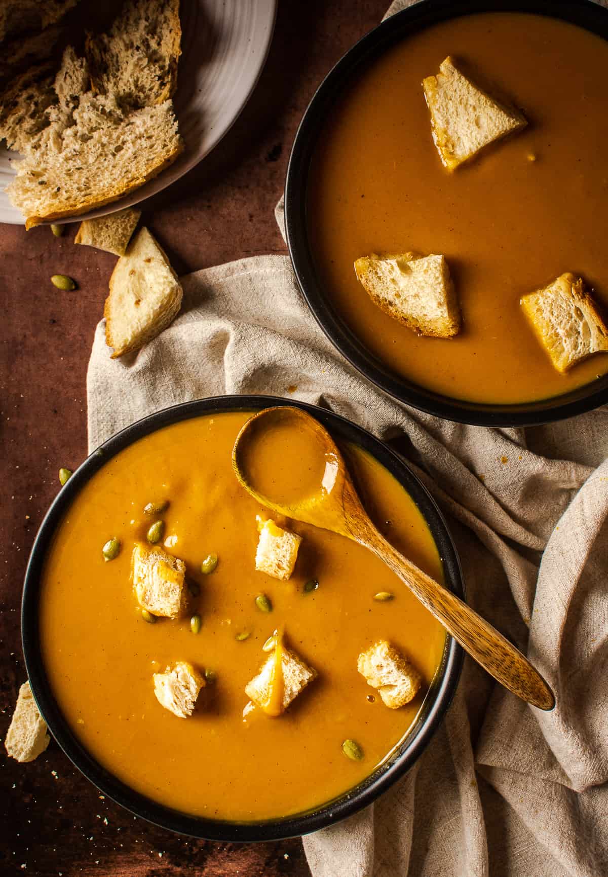 sweet potato soup in bowl with a spoon