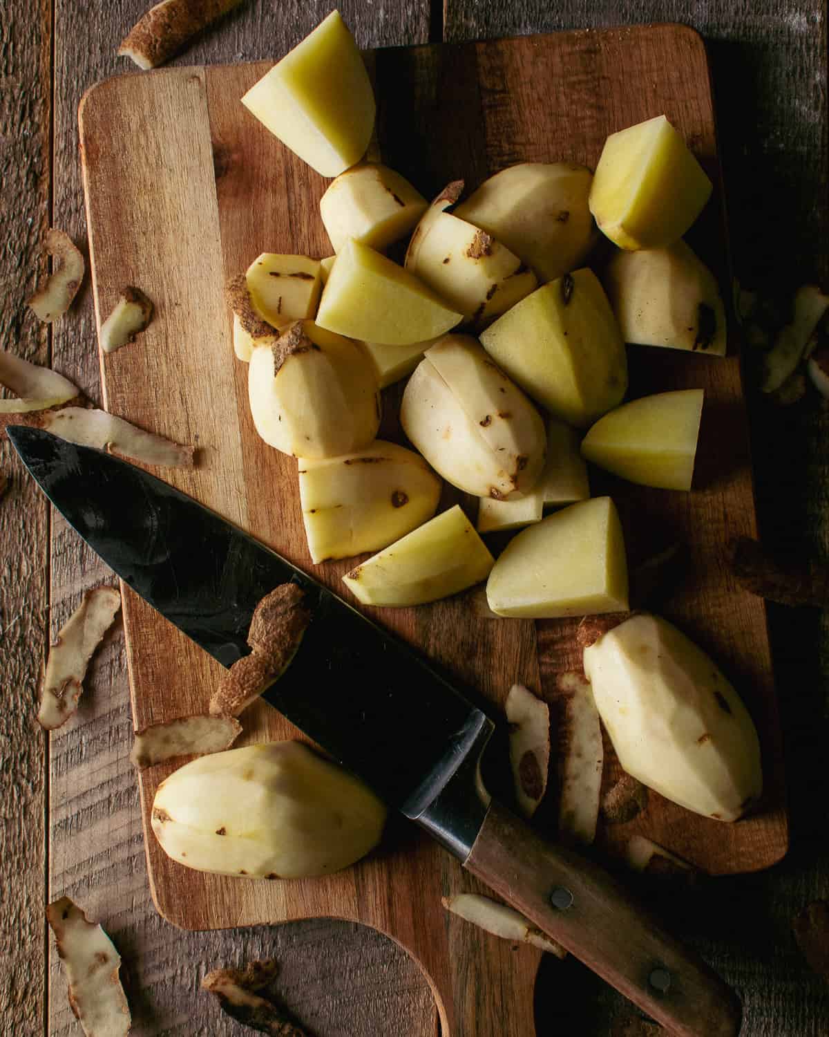 diced potatoes on cutting board with knife.