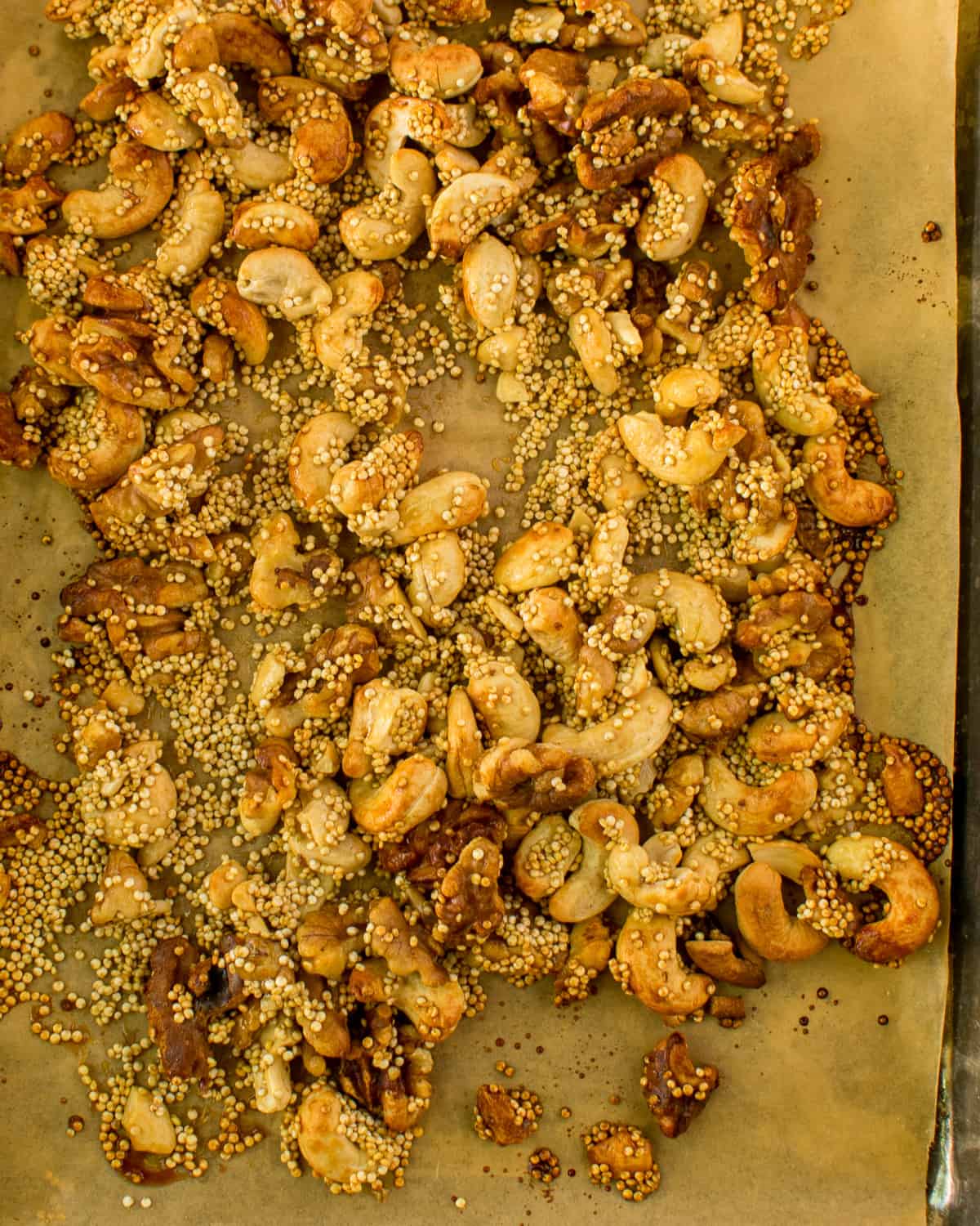 roasted nuts and quinoa on baking sheet