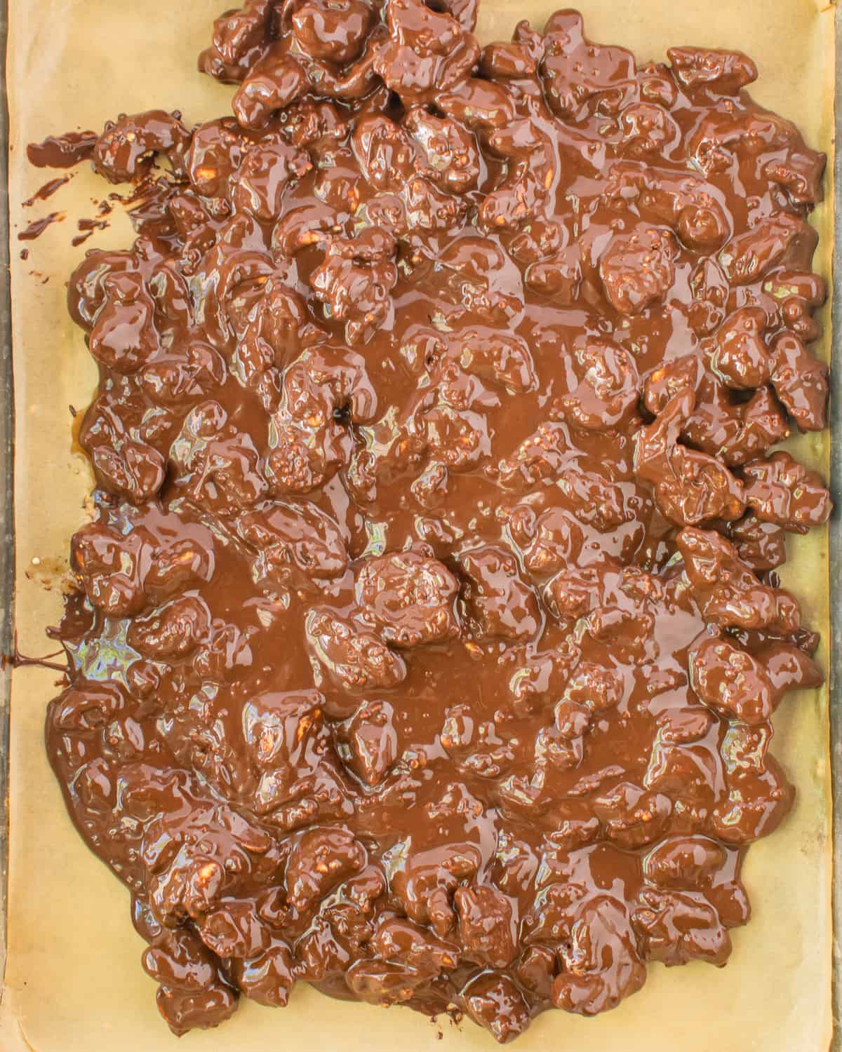 melted chocolate and nuts on baking sheet.