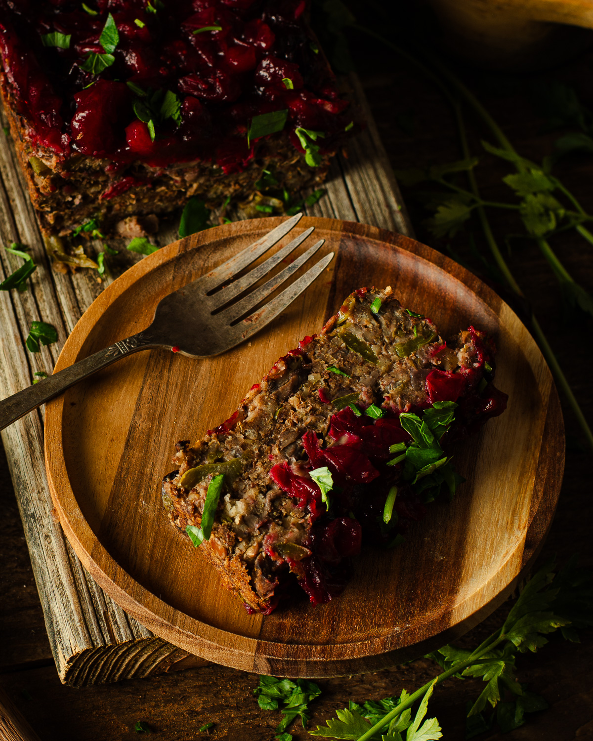 Mushroom-Lentil Loaf with Cranberry Glaze on plate with fork.